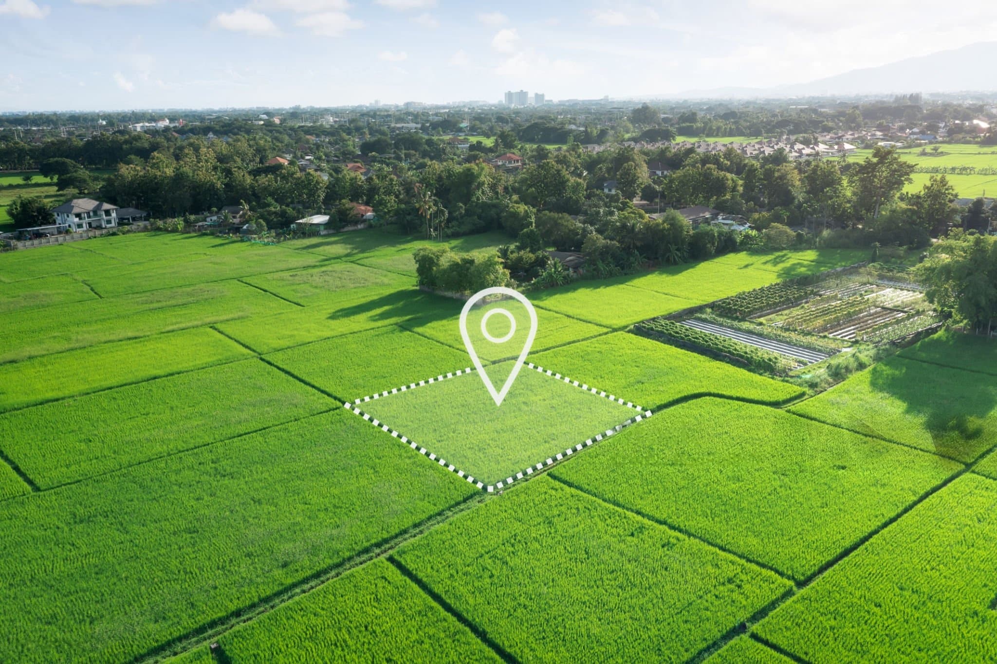 Aerial view of green rice paddies with GPS location marker and boundary verification overlay